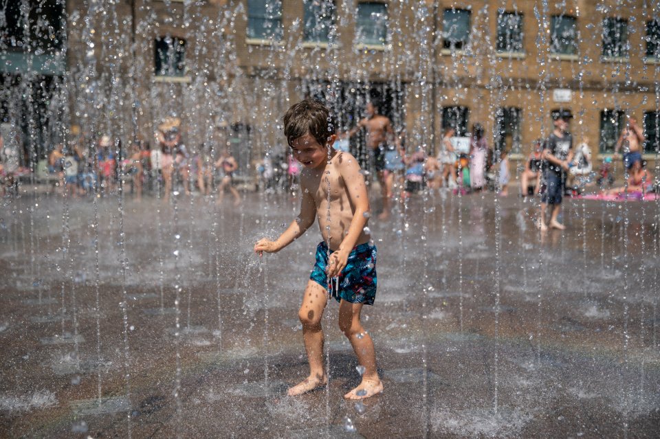  Children play in the fountains at Granary Square, London, as temperatures approach record levels