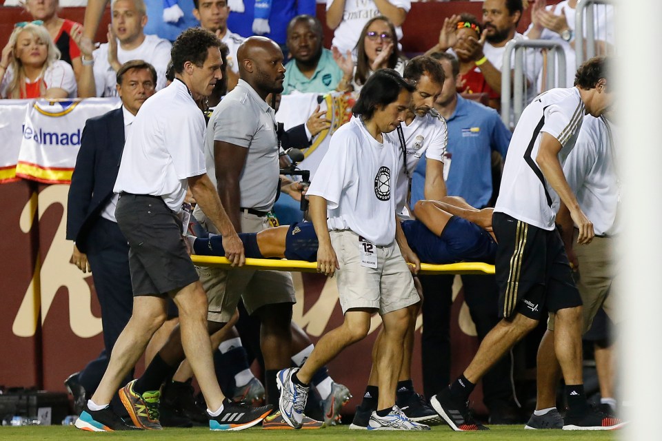  Marco Asensio is carried off in agony after suffering a feared knee ligament injury