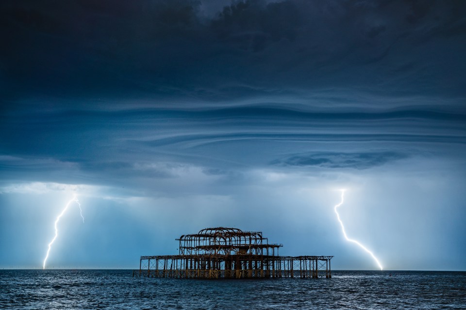  Two lightning bolts frame Brighton's West Pier on the South Coast on Tuesday night