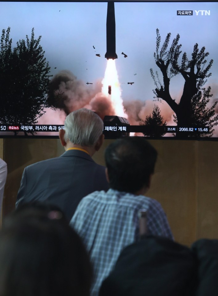  South Korean people watch breaking news of North Korea's missile launch, at Seoul Station