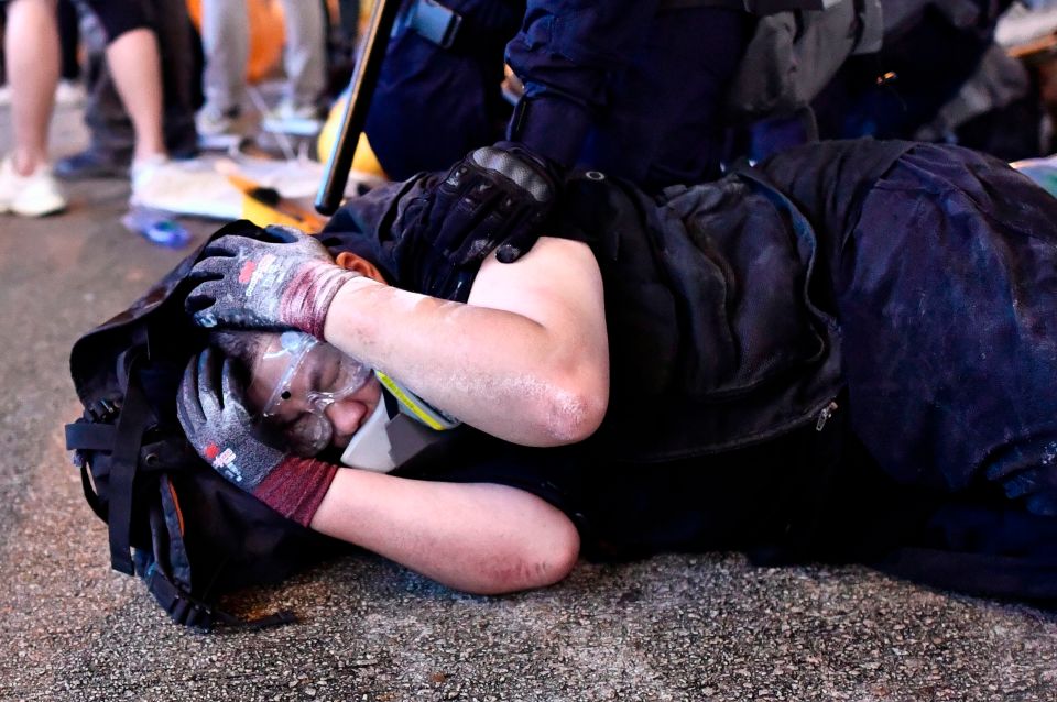  A protester is detained by police during a demonstration against a controversial extradition bill in Hong Kong