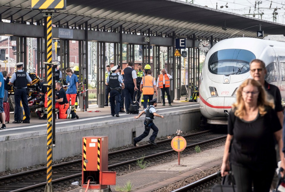  A cop races across the tracks after a boy, 8, was killed by a train