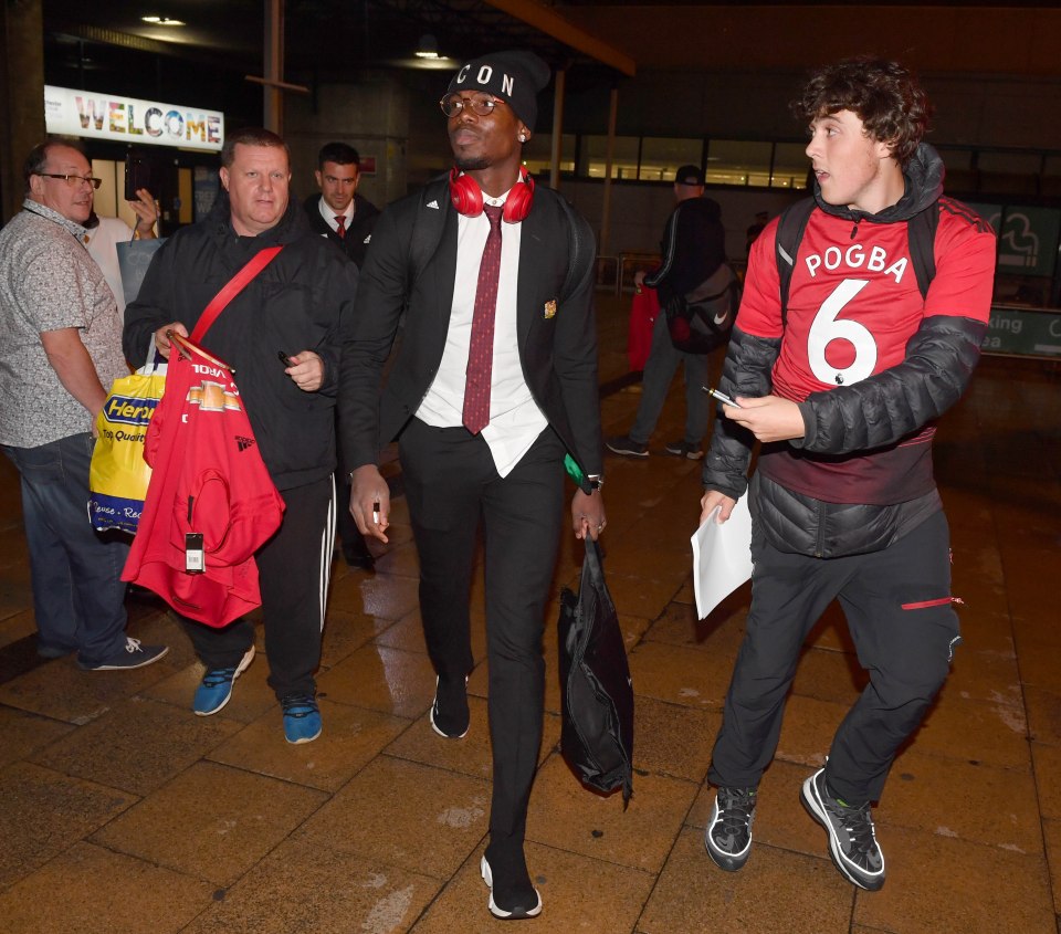  Paul Pogba did his best to avoid fans as Man Utd arrive back in England