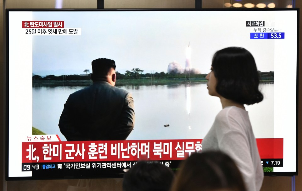  North Korea has fired 'multiple' suspected missiles in its latest brazen weapons test. Above, commuters watch the broadcast