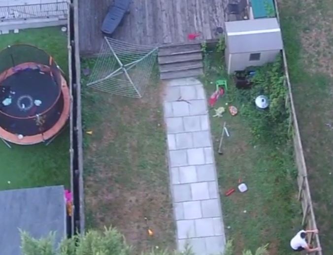 A man can be seen jumping over numerous fences in an attempt to escape