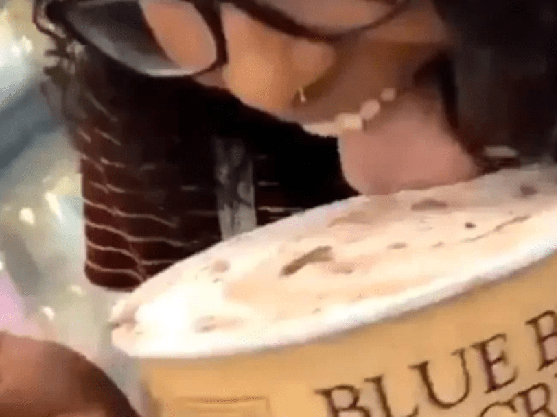  Sickening viral footage shows a woman licking ice cream from a tub before placing it back in a supermarket freezer