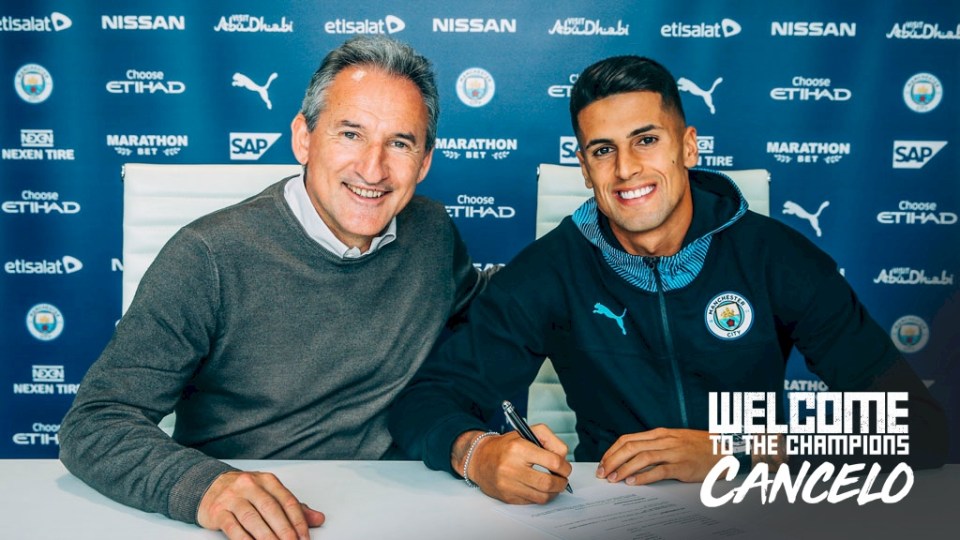 Joao Cancelo, with Txiki Begiristain, signs a six-year deal with Man City