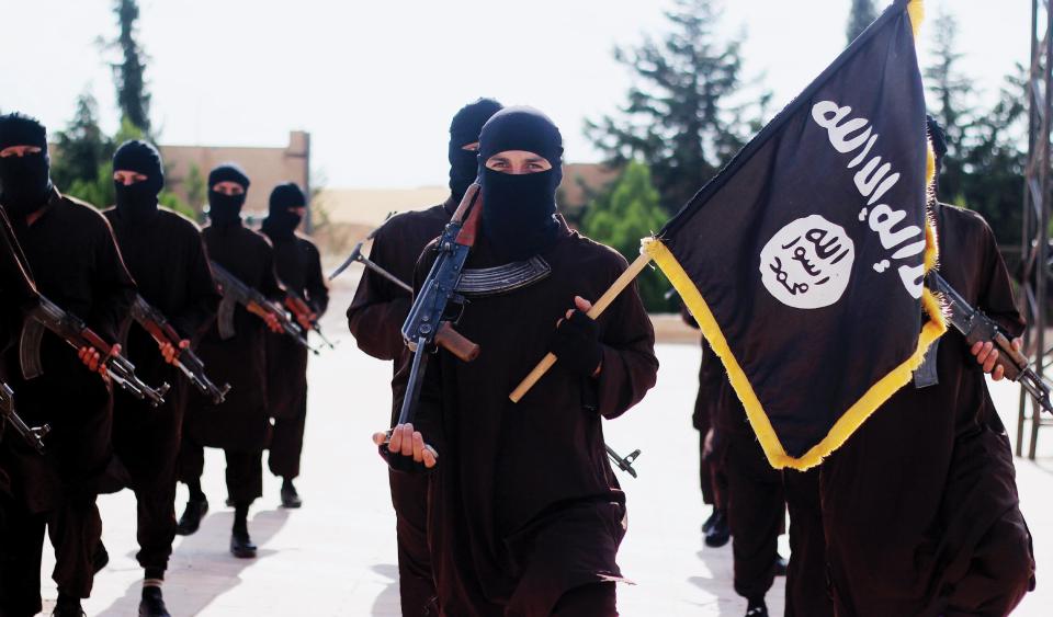  ISIS propaganda photo showing masked militants holding the terror group's banner