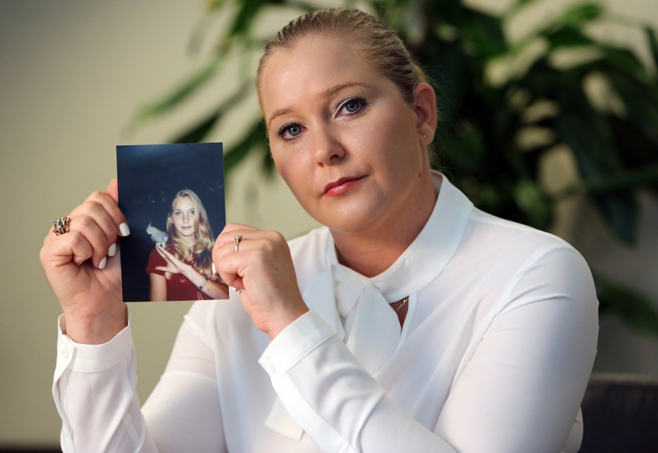 Virginia Roberts holds a photo of herself taken a year after she claims she was first abused by Epstein