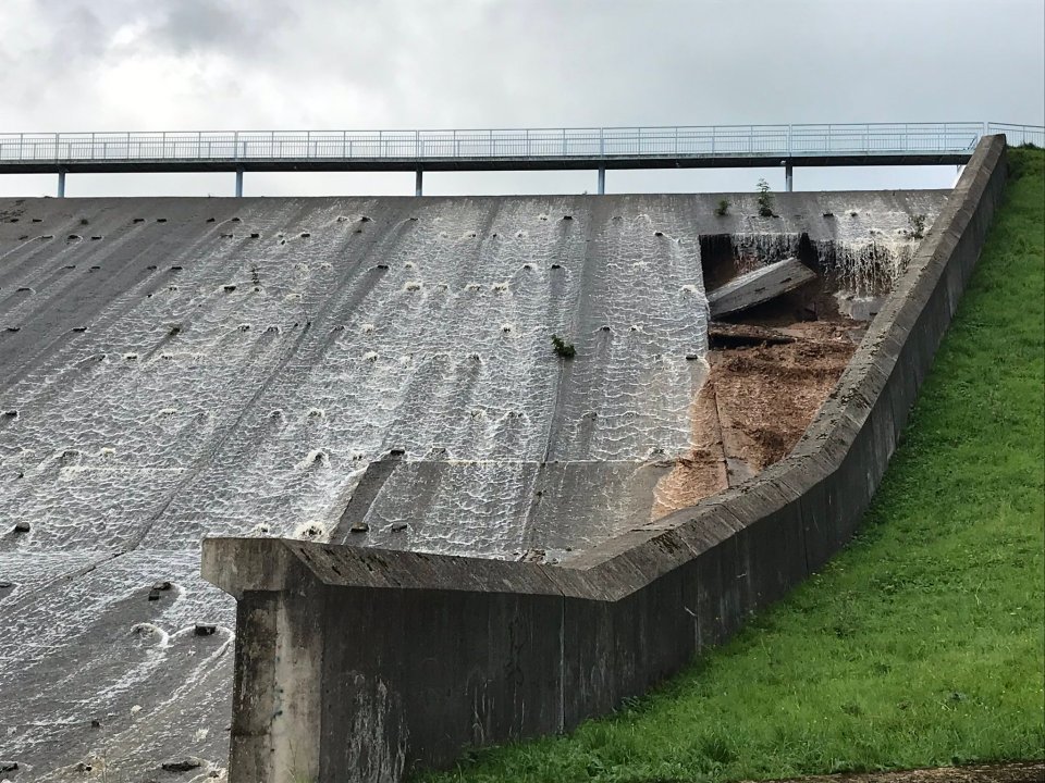  Photographs show the Toddbrook Reservoir badly damaged