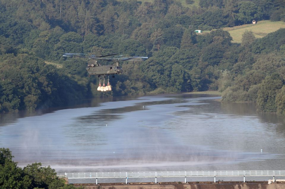  The dam holding back the huge expanses of water is desperately being shored up