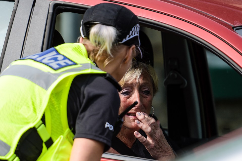  A woman broke down as she spoke to a police officer when she was given a 15-minute window to go into her home