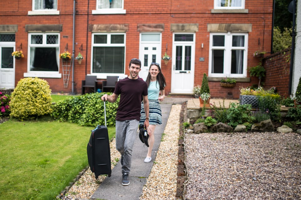  Residents Jamie and Sophie Richardson pack belongings into their car before leaving Whaley Bridge in Derbyshire