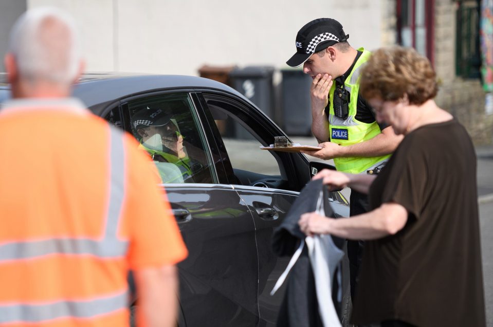  A police officer talks to a resident during a fifteen minute window