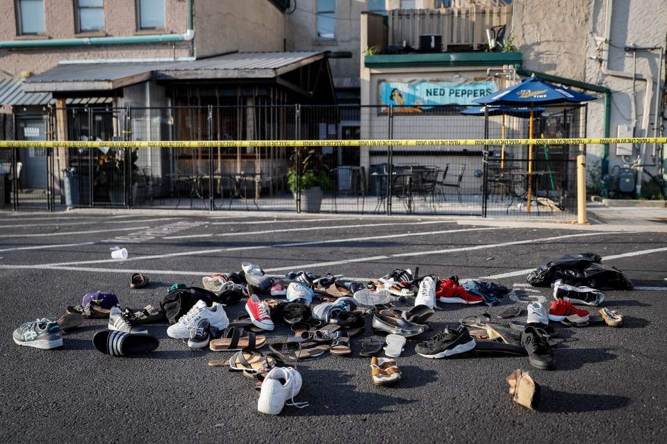  Shoes are piled outside the scene of a mass shooting where one of the locations was Ned Peppers bar