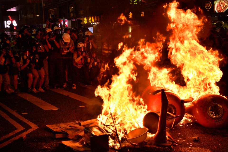  Protesters lit fires in the streets as the city entered its ninth week of unrest