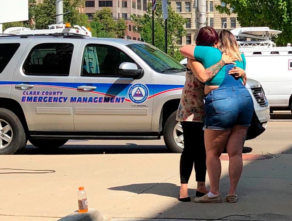  Residents comfort each other as they await word on whether they know any victims of the mass shooting