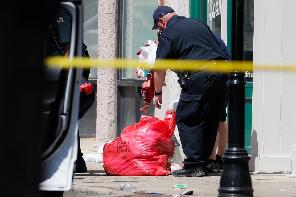  Authorities remove bloody rags and debris at the scene of a mass shooting in Dayton, Ohio