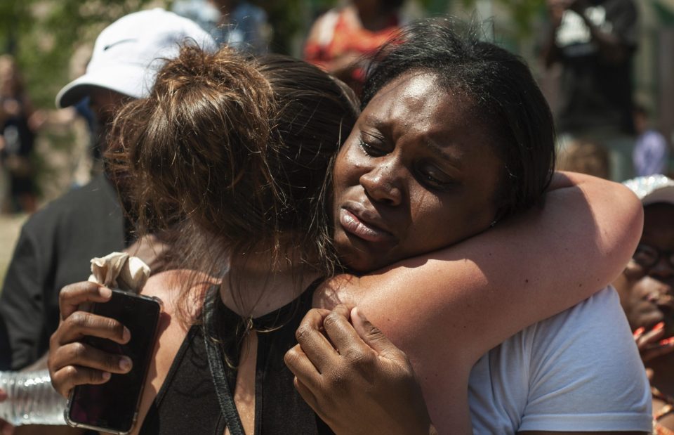  People console each other as they gather for a vigil in Dayton, Ohio