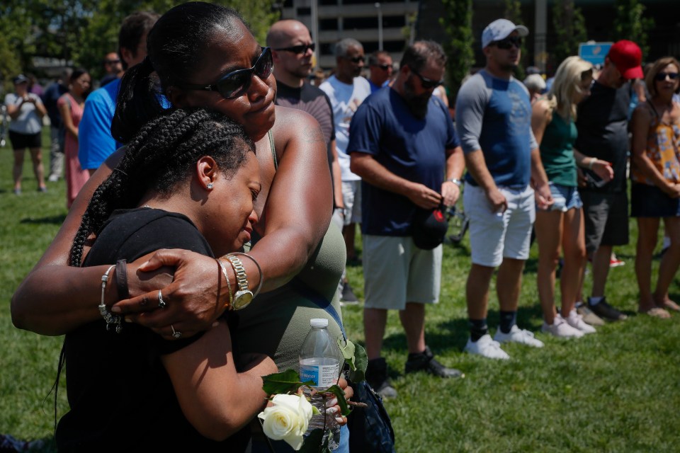  Mourners gather at a vigil in Dayton less than 24 hours after a mass shooting in Oregon district of the town