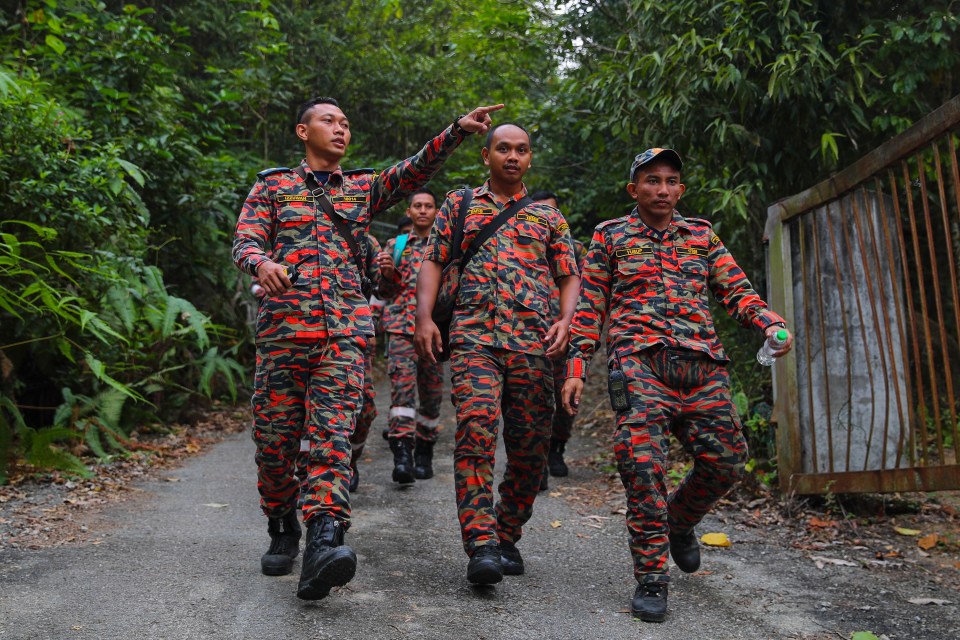  Members of a Malaysian Fire and Rescue Department team continue the search and rescue operation