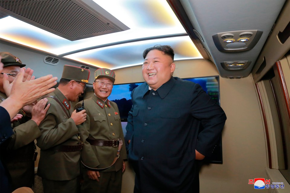  North Korean leader Kim Jong-un celebrates a rocket test carried out by his regime