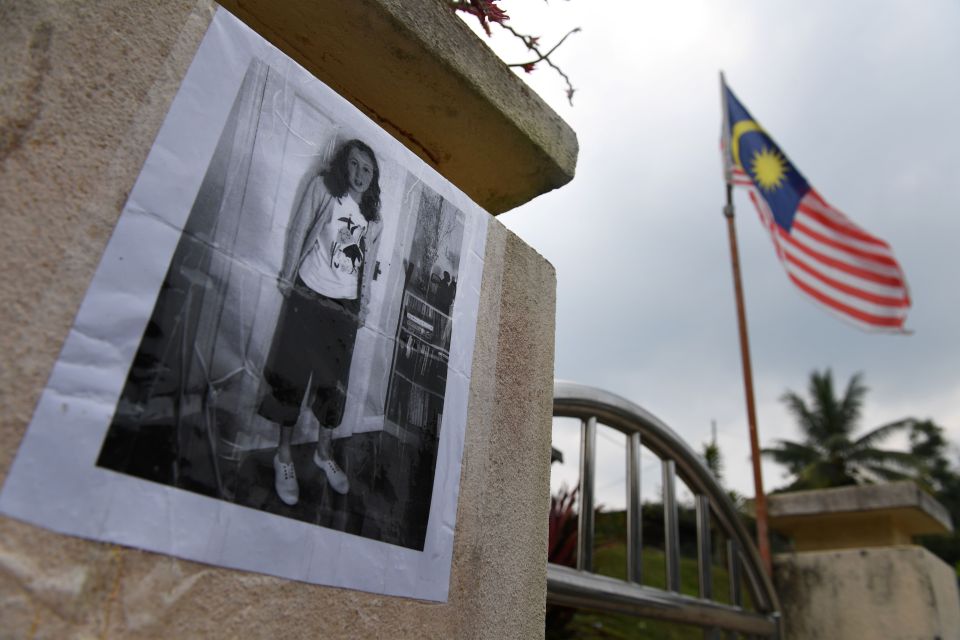  A poster showing teenager Nora Quoirin is displayed outside a school