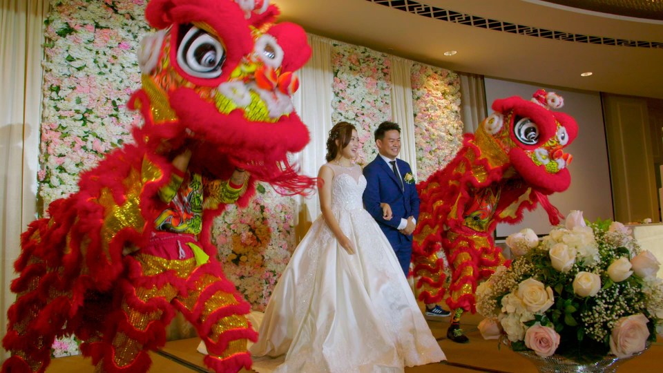  After the ceremony, the couple stood on stage with dragons to scare off any 'evil spirits'