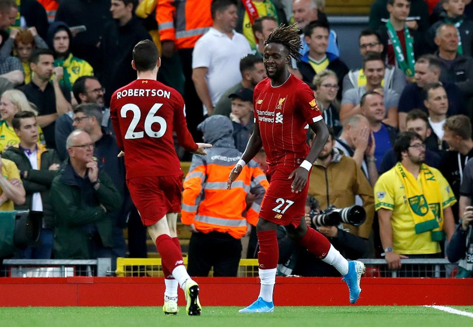 Origi is all smiles as he celebrates the strike with Andrew Robertson