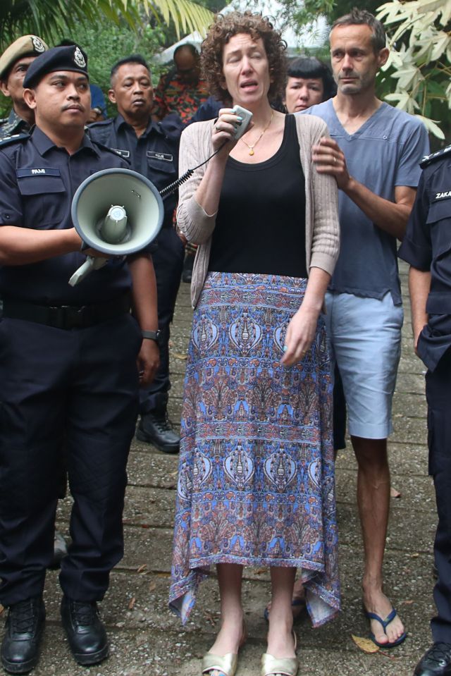  Meabh and Sebastien Quoirin use a loudspeaker to call out to their missing daughter Nora as they continue their search