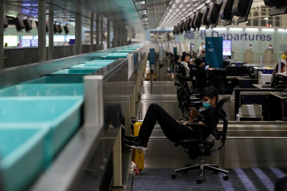  A demonstrator rests at the check-in counter in the departure hall