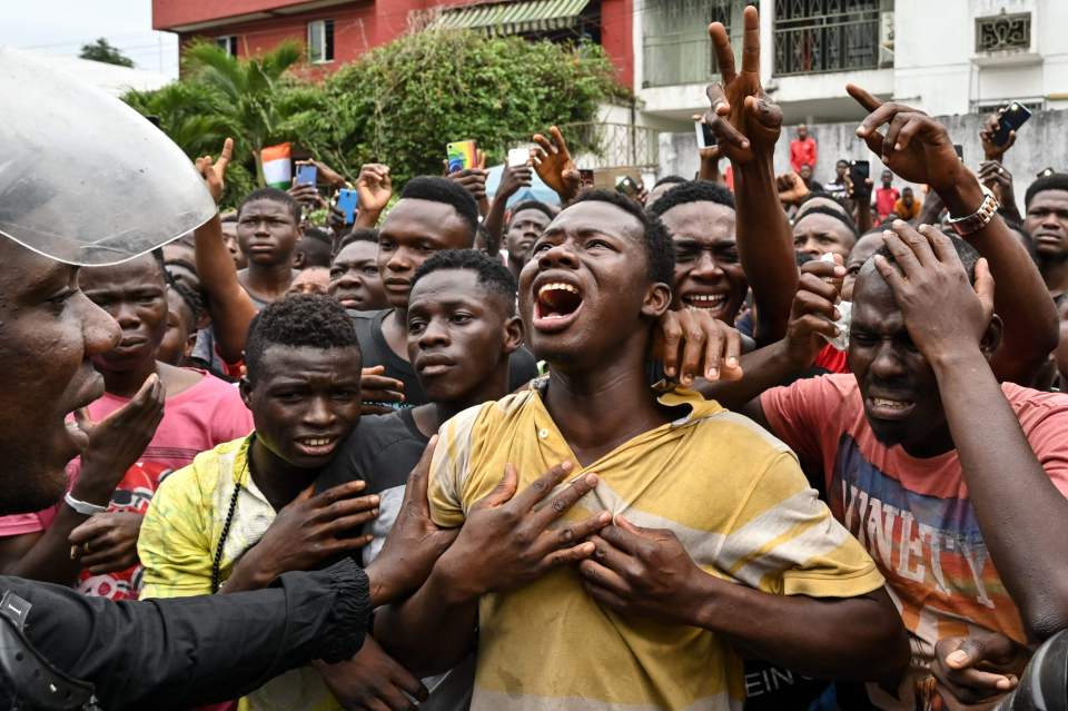  Fans are seen crying outside a hospital in Abidjan