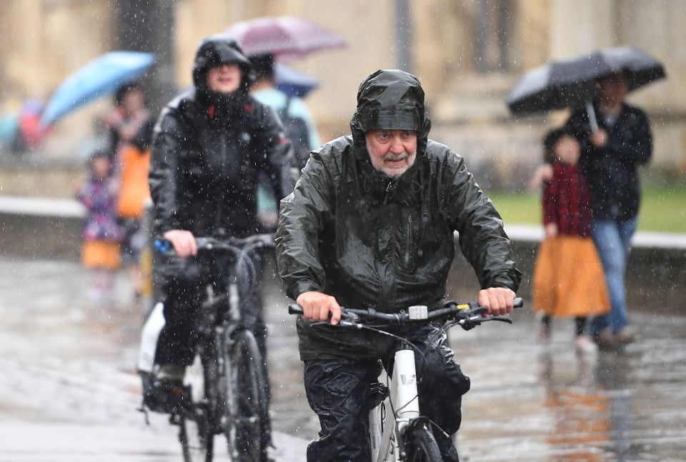  People in Cambridge battled the heavy rain this afternoon