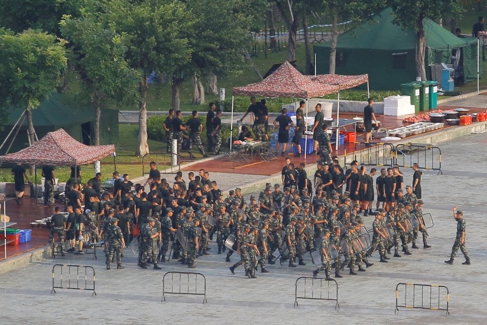  Chinese soldiers walk in formation on the grounds of the Shenzhen Bay Sports Center