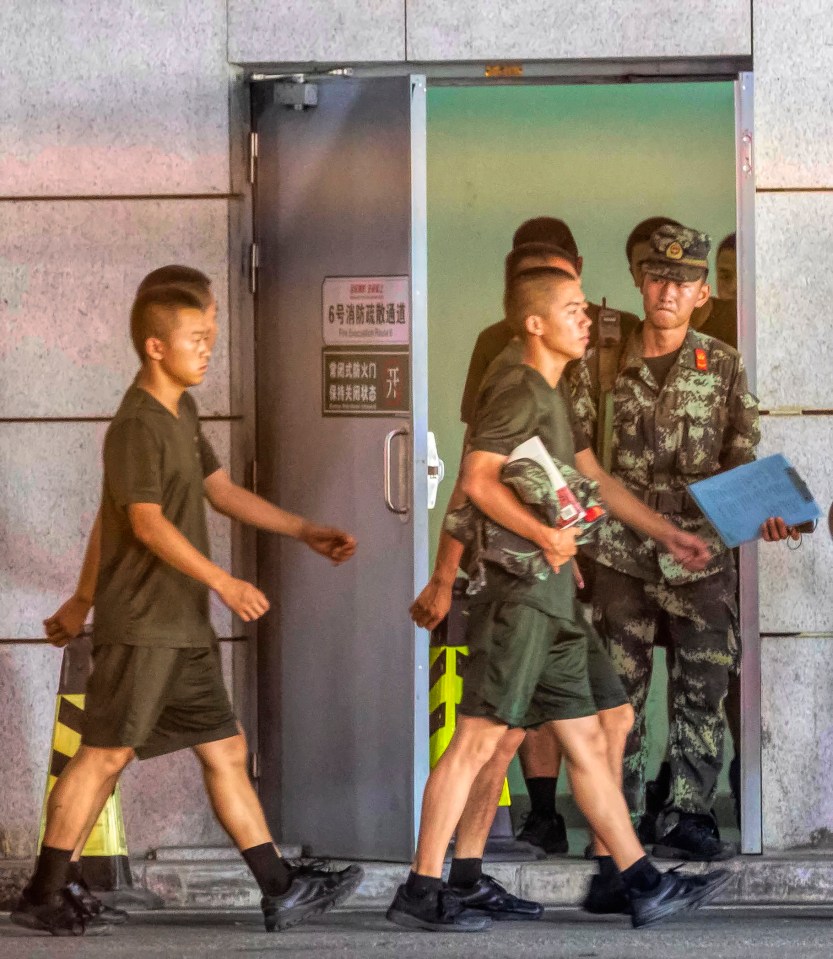  Members of PAP exit through garage underground entrance of the Shenzhen Bay Sports Center