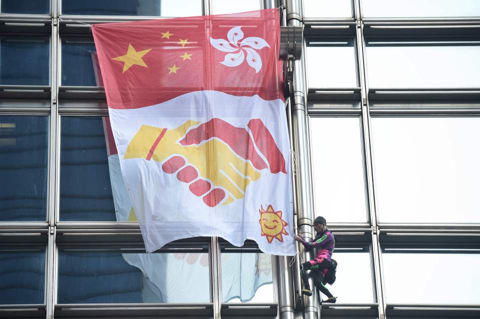  Alain Robert, a French rock climber scales Cheung kong centre building in Hong Kong