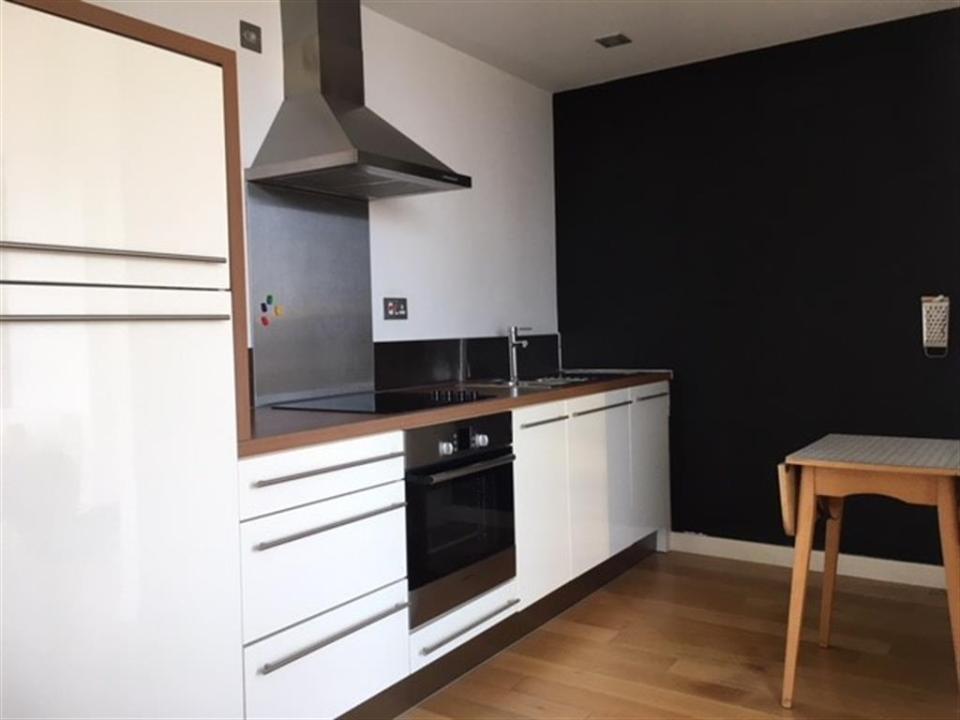  The apartment features a sleek white kitchen