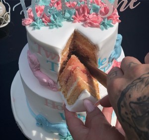  They announced the news to guests at the party by cutting into a pink cake