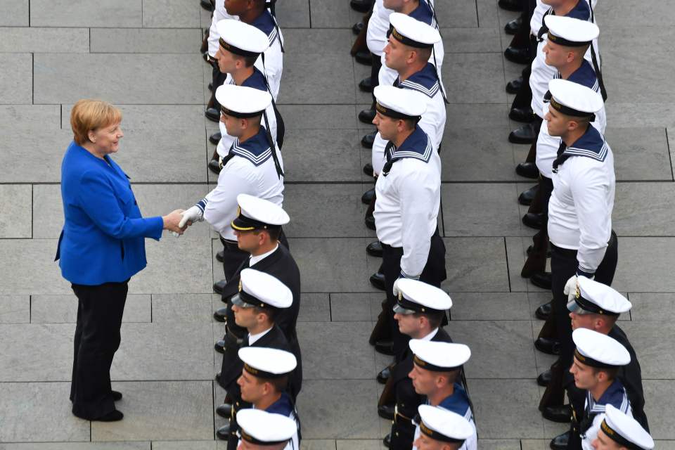  Merkel greeting a member of the honour guard on his birthday before Boris arrived