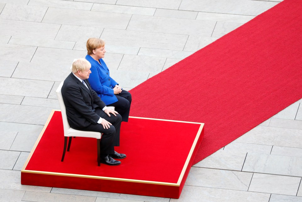  The pair sat on the red carpet as they listened to their national anthems