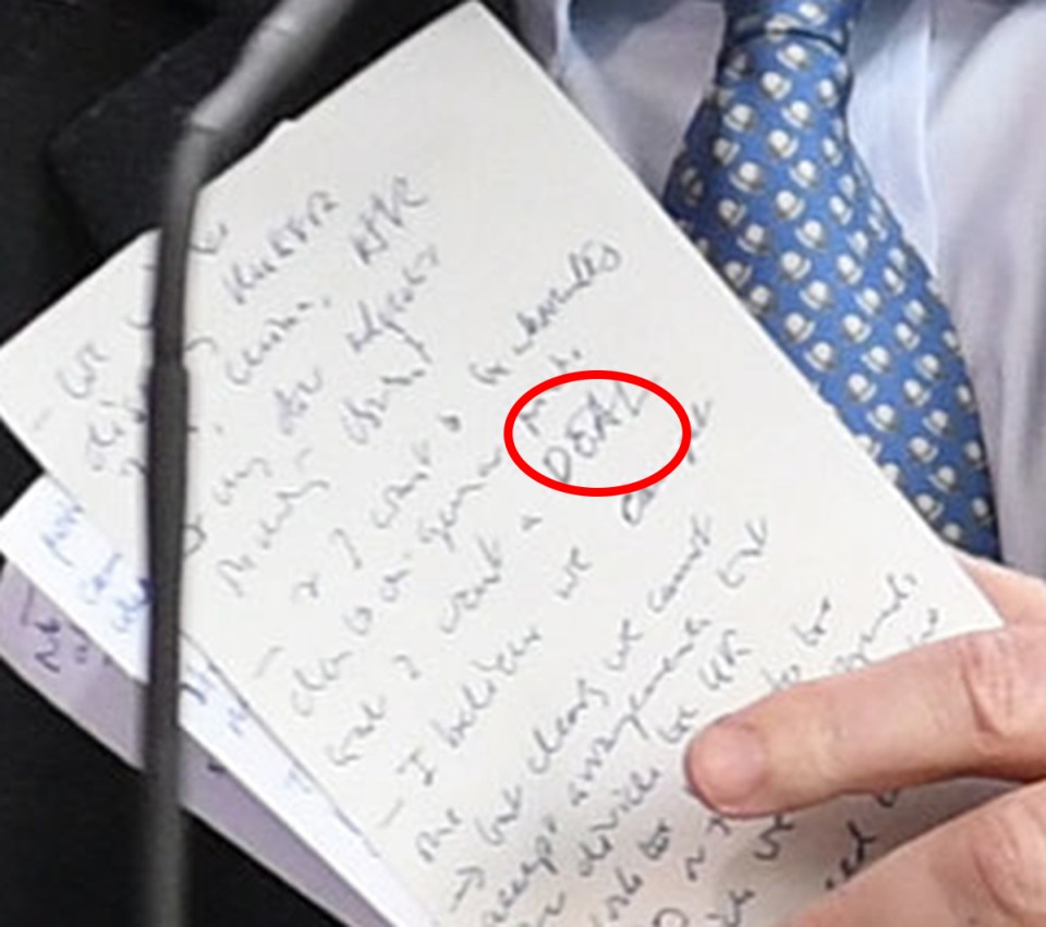  Mr Johnson holds his notes, following the press conference with Mrs Merkel