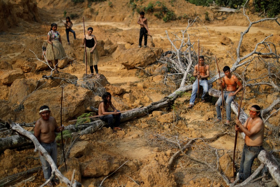  People from the Mura tribe show a deforested area inside the Amazon rainforest