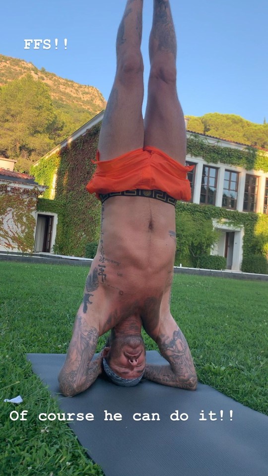  David avoids bending it like Beckham as he pulls off a perfect yoga headstand