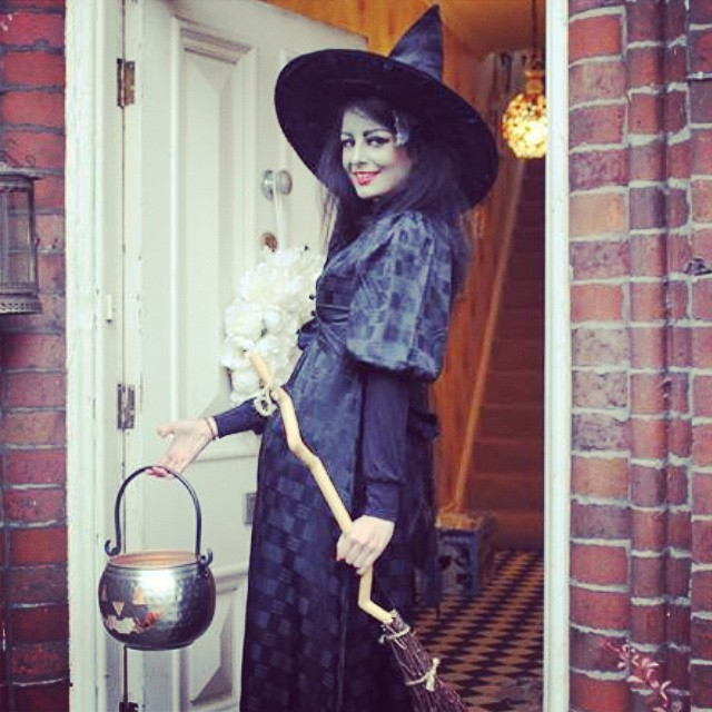  She posed in a witch costume, equipped with a broom and cauldron