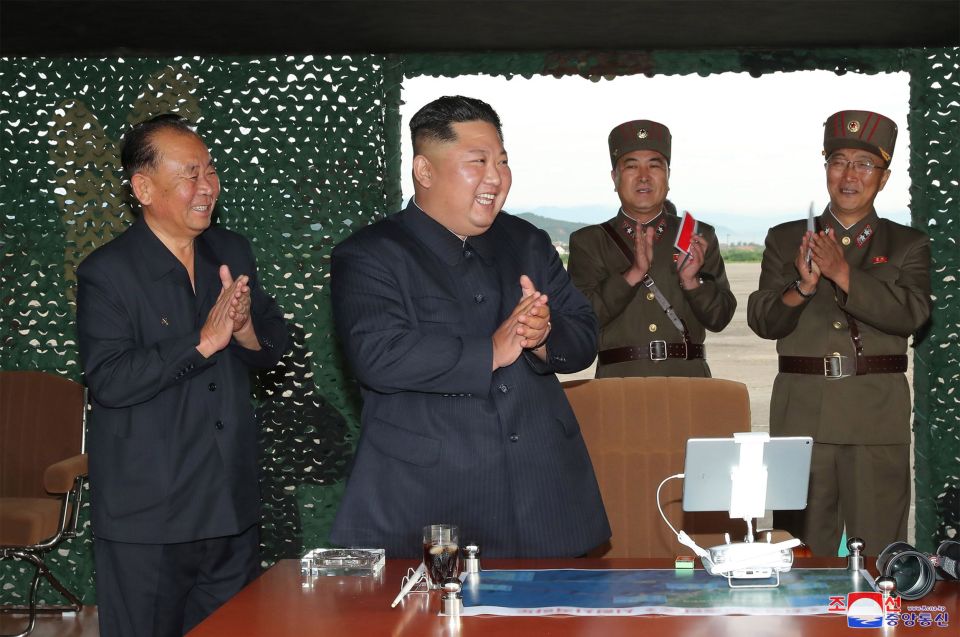  Looking happy - Kim Jong-un claps after the successful firing