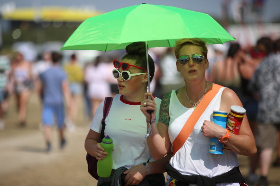  Quick thinking for this couple at Leeds festival, ensuring that they stay protected from the sun with a bright green brolly