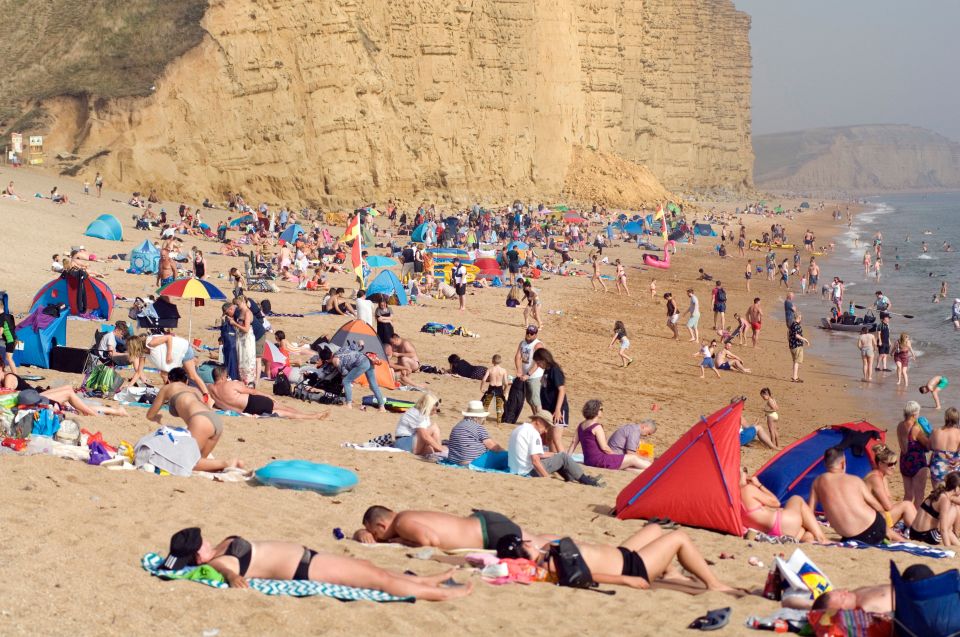  Visitors soak up the sun on the Jurassic Coast