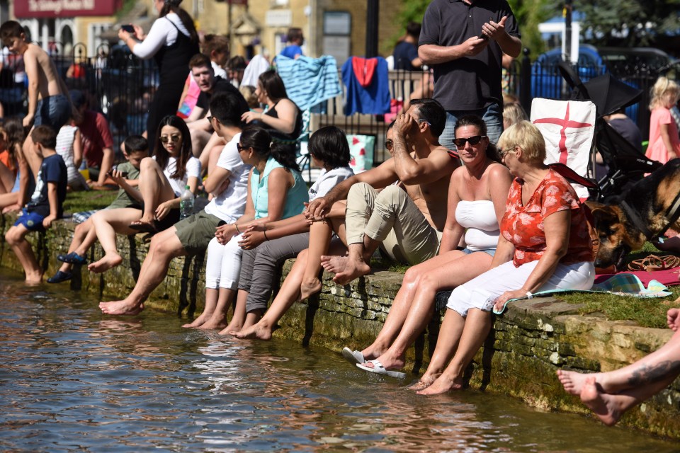  Some of the fans sit by the water and dip their feet in to cool down