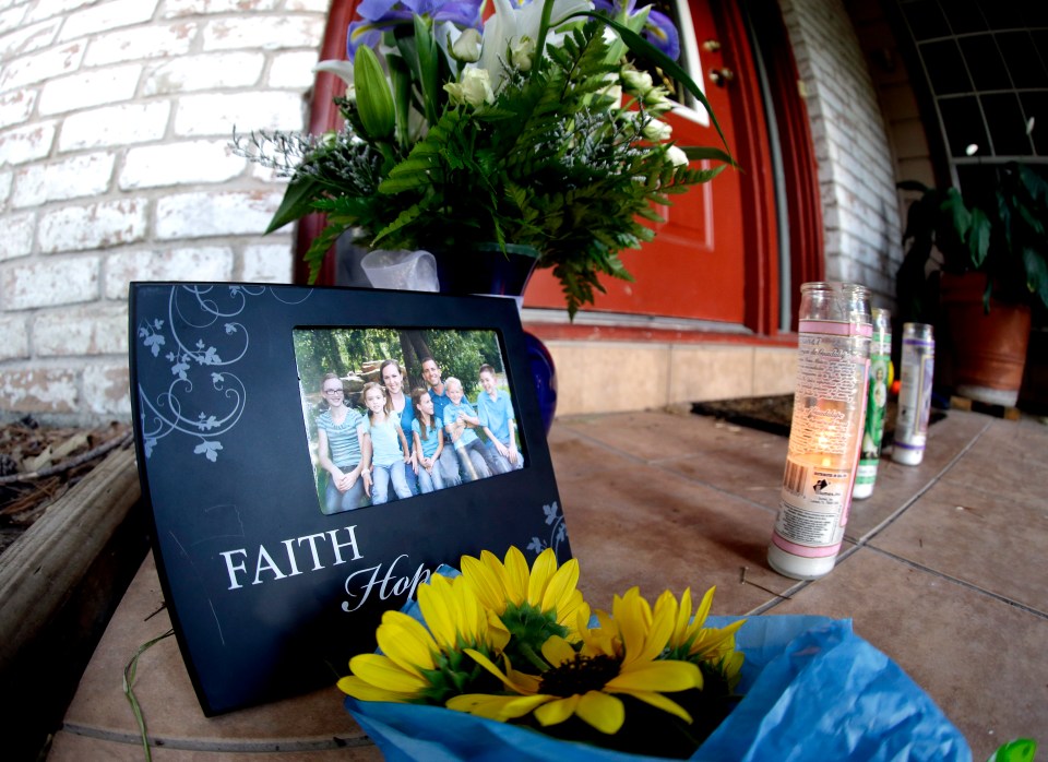  A photograph, flowers and candles are left on the porch where a fatal home shooting took place