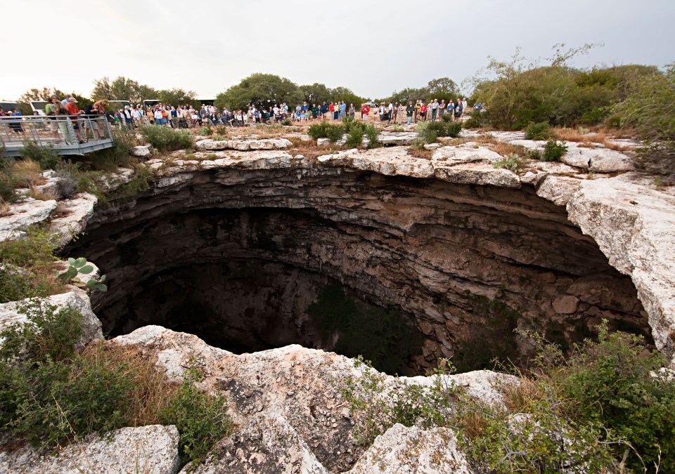  The huge sinkhole is now the dark home to millions of bats who swarm out of the depths at nightfall